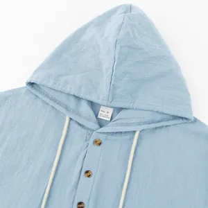 Close-up of light blue linen men's hooded Henley shirt with buttons and drawstrings