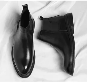 Detailed top and side view of black leather Chelsea boots for men with elastic panels