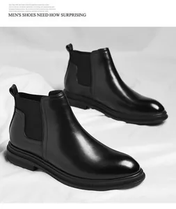 Detailed view of polished black faux leather Chelsea boots for men on white fabric
