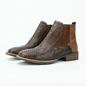 Detailed side view of men's brown Chelsea boots with faux snakeskin texture