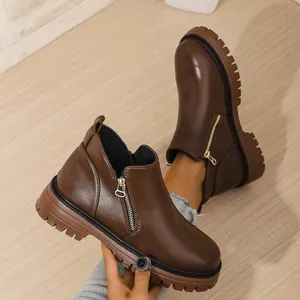 Vintage brown women's Martin boots with side zipper, round toe, and thick lugged sole