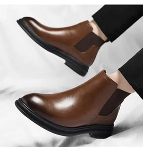 Close-up shot of stylish brown leather men's Chelsea boots featuring elastic side panels