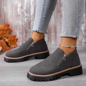 Side view of grey suede loafers with functional zipper and platform sole