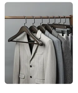 Close-up of premium dark beech wood suit hangers with non-slip wide shoulders on a rack
