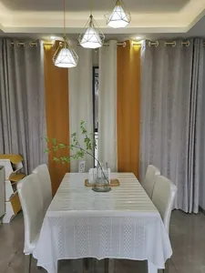 French style white embroidered lace tablecloth in a modern dining room setting.