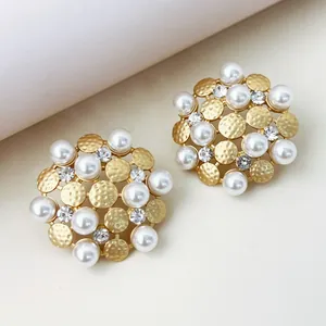 Macro detail view of vintage sunflower stud earrings with elegant pearls and crystals