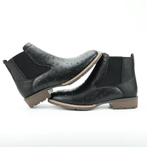 Detailed shot of black men's Chelsea boots with embossed ostrich skin texture