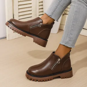Vintage brown mid-top Chelsea boots featuring side zipper and chunky lug platform sole