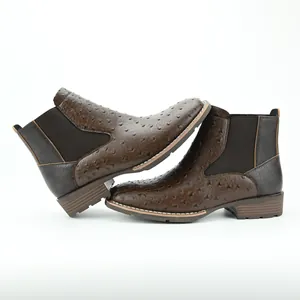 Detailed side view of brown men's Chelsea boots featuring ostrich print texture