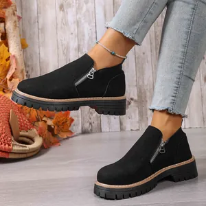 Detailed side view of black round-toe casual loafers featuring a zipper and chunky sole.