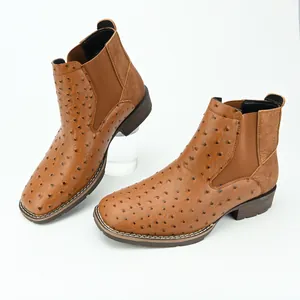 Detailed view of men's brown Chelsea boots featuring a textured ostrich skin pattern
