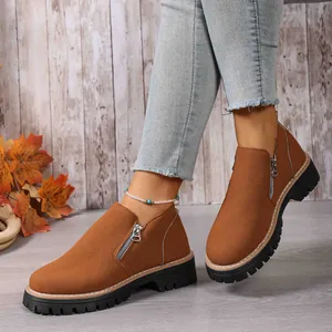 Close-up of brown suede loafers with side zipper and thick black platform sole