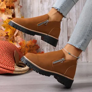 Close-up detail of brown suede casual shoes with side zipper and thick black lug sole