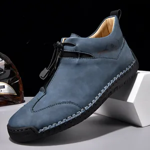 Blue laceless men's casual leather shoes with zipper detail and decorative stitching