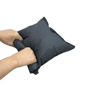 Hand-roll vacuum compression bag for travel storage with striped fabric design.