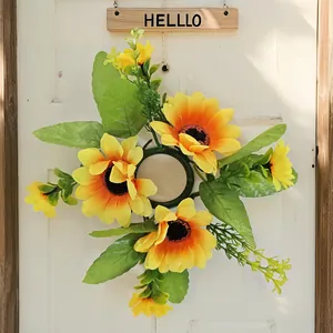 Detail of artificial sunflower wreath with vibrant yellow petals and green leaves