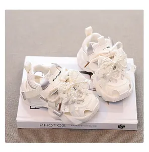 Detailed close-up view of toddler girls' white mesh sandals featuring a lace pearl bow.