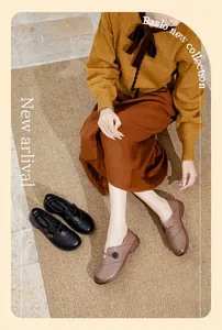 Close-up detail view of retro brown and black slip-on leather loafers for elderly women.