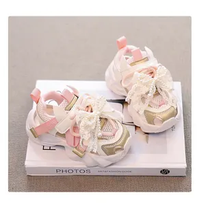 Detailed shot of pink girls' princess sneakers with lace bows and pearl accents.