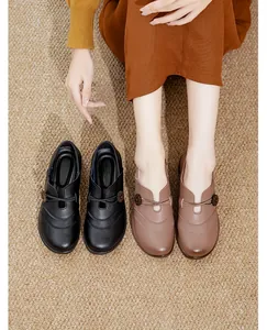 Close-up detail of brown and black slip-on shoes for elderly women with soft soles