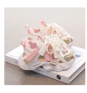 Detailed view of pink girls' mesh sports sandals with lace bow and pearl accents