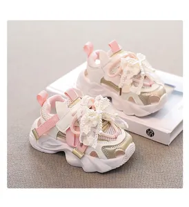 Detailed view of breathable pink girl's sneakers featuring an elegant lace bow and pearls.
