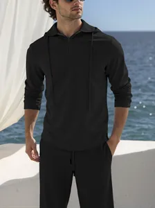 Men's minimalist black textured tracksuit set with half-zip hoodie and long pants