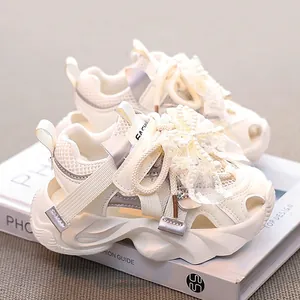 Girls' cream mesh sports sandals shown from a side angle with elegant lace bow details