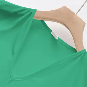 Macro view showing the V-neckline and stitching detail of a green quick-dry men's vest