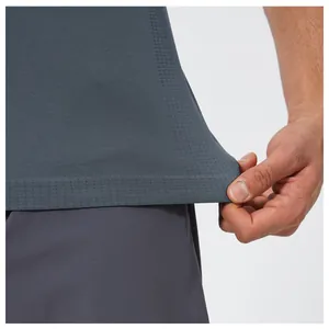 Close-up of breathable fabric texture on a gray seamless men's sports fitness t-shirt.