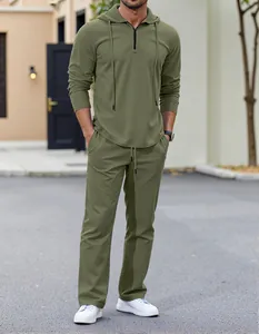 Full view of men's olive green linen hoodie and trousers leisure set on model.