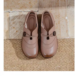 Overhead view of comfortable taupe slip-on loafers with decorative floral button details
