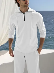 Detail view of white linen casual set featuring hooded half-zip shirt and matching pants
