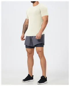Man in off-white seamless muscle fit gym T-shirt and grey athletic shorts