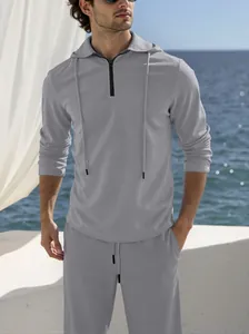 Premium men's grey textured linen hooded set with quarter-zip long-sleeved top.