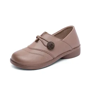 Comfortable taupe slip-on flat shoes with a decorative flower for elderly women