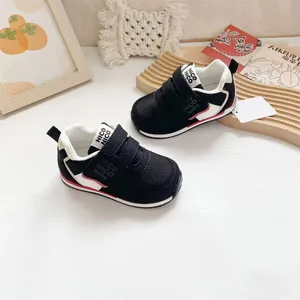 Detailansicht schwarzer, atmungsaktiver Kleinkind-Sneaker mit roten Akzenten und Klettverschluss