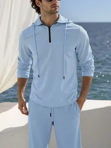 Detailed view of men's light blue textured linen-style hoodie and pants set