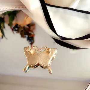 Detail view of vintage butterfly brooch back with secure golden safety pin closure