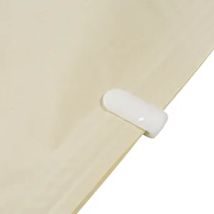 Close-up detail of white sealing clip on a durable beige vacuum storage bag for bedding