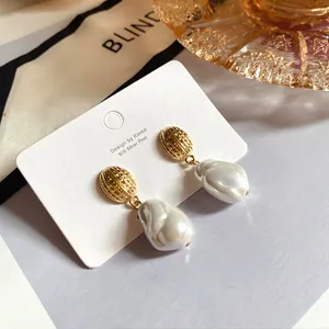 Dettaglio ravvicinato di orecchini vintage con perle barocche e perno in argento 925