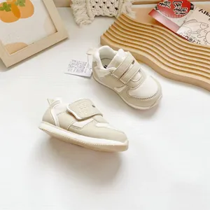 Atmungsaktive cremefarbene Retro-Sneaker für Kleinkinder mit Klettverschlussriemen.