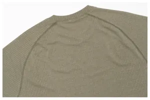 Close-up of olive green breathable mesh fabric on men's seamless sports T-shirt