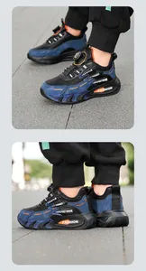 Detailed view of boys black and blue mesh sneakers featuring a rotary buckle system