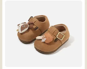 Detailed view of brown baby walking shoes with cute raccoon and mushroom accents