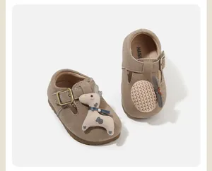 Detailed view of beige suede baby walking shoes with cute animal and knit accents