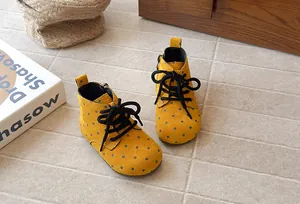 Detailed view of yellow polka dot toddler Martin boots with soft soles and side zipper