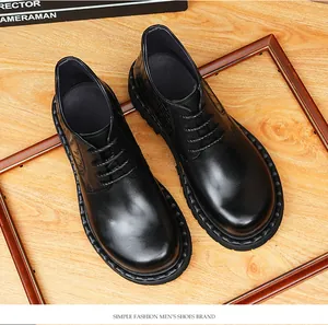 Detail view showing men's black leather Martin boots featuring stylish crocodile pattern