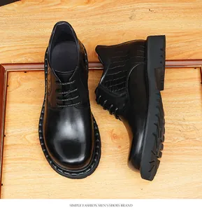 Close-up detail of black men's leather boots with crocodile texture and thick sole