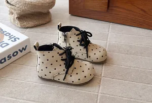 Cozy view of toddler girl polka dot ankle boots with soft soles in lifestyle scene